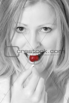 Pretty woman eating a cherry 