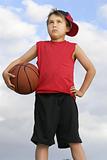 Standing child holding a basketball