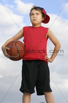 Standing child holding a basketball