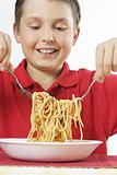 Child tossing pasta