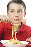 Child with forkful of noodles