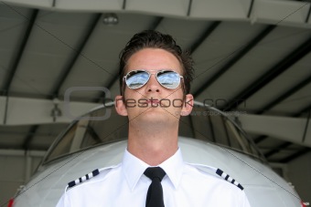 Pilot and airplane in hangar