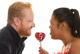 Two people share a candy