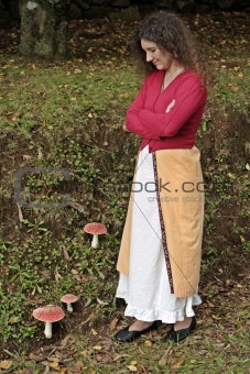 Lady looking at red mushrooms