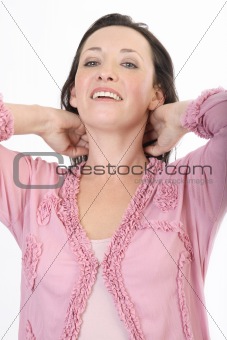 Portrait of lady in pink 5 with hands behind her neck laughing