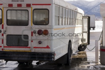 White School Bus Pumping Gas