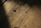 Detail of wooden floor with debris