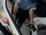 Policewoman arresting someone