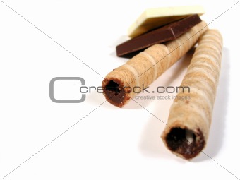 Chocolates and biscuits on white 