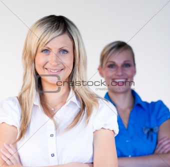 Businesswoman smiling at the camera with her colleague 