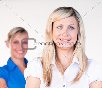 Businesswoman smiling at the camera with her colleague 