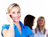 Smiling businesswoman speaking on the phone in office