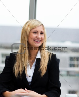 Smiling blonde businesswoman talking to a colleague