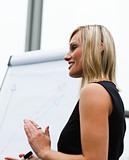 Beautiful businesswoman clapping after a presentation