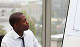 Afro-American businessman looking at a whiteboard