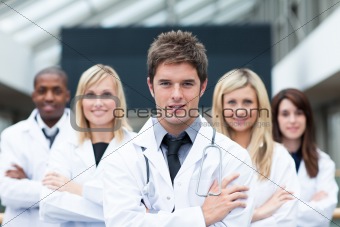 Handsome young doctor leading his team