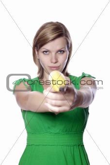girl holds banana as a gun