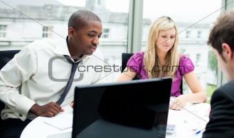 Multi-ethnic business team interacting with each other