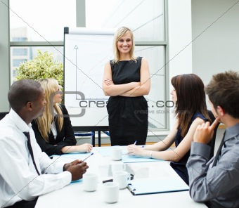 Attractive businesswoman in a meeting with folded arms