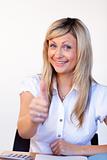 Beautiful businesswoman with thumbs up in office
