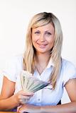 Smiling businesswoman holding dollars