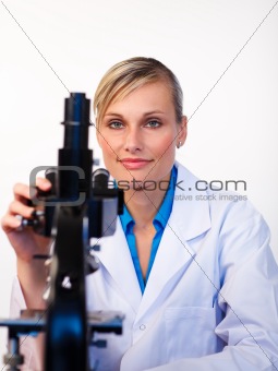 Beautiful scientist working with a microscope 