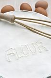 Word "flour" handwritten in flour