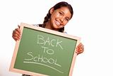 Pretty Hispanic Girl Holding Chalkboard with Back To School Isolated on a White Background.