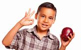 Adorable Hispanic Boy with Apple and Okay Hand Sign Isolated on a White Background.