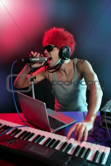 Dj with colorful light and music mixing equipment