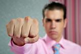 angry aggresive businessman with fist closeup