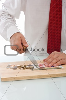 Businessman cutting the currency