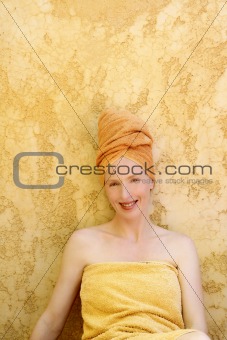 Beautiful woman with orange towel in head
