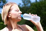 Pretty woman drinking water