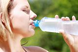 Pretty woman drinking water