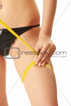 Slim woman measuring her leg