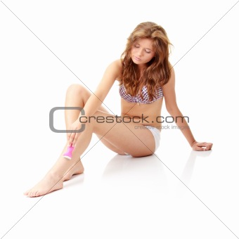 Woman depilating her legs
