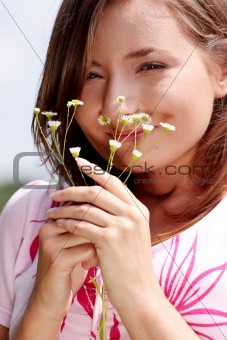 Young girl in blooming meadow