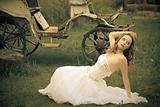 beautiful bride and an old  carriage