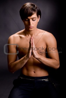 Youth praying with clasped hands