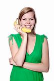 girl holds banana as a phone
