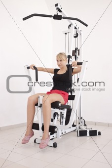 Young blond woman working out in gym