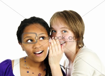 Two girlfriends whispering