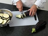 Chef slicing eggplant