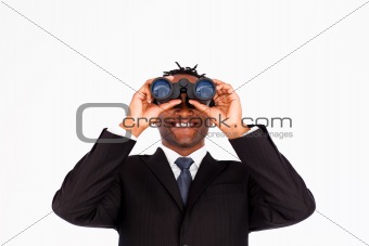 Handsome businessman holding binoculars upwards 