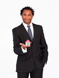 Afro-american businessman presenting house 