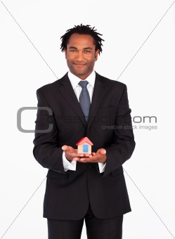 Afro-american  businessman presenting a house 