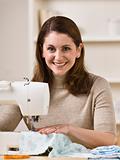 Smiling Woman Using Sewing Machine