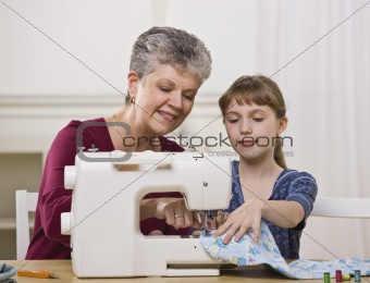 Grandmother Sewing with Granddaughter