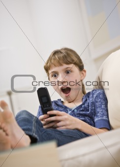 Excited Young Girl Looking at Cell Phone